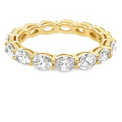 Eternity band east west style in 18K YG with basket prong set (14) oval diamonds.  D2.88ct.t.w.  Size 6