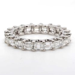 East to west style eternity band with prong set (20) emerald cut diamonds.  D3.03ct.t.w.