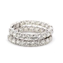 1.25' Oval shaped inside out hoop earrings with shared prong set (34) round diamonds & with special spring lock.  D8.12ct.t.w.