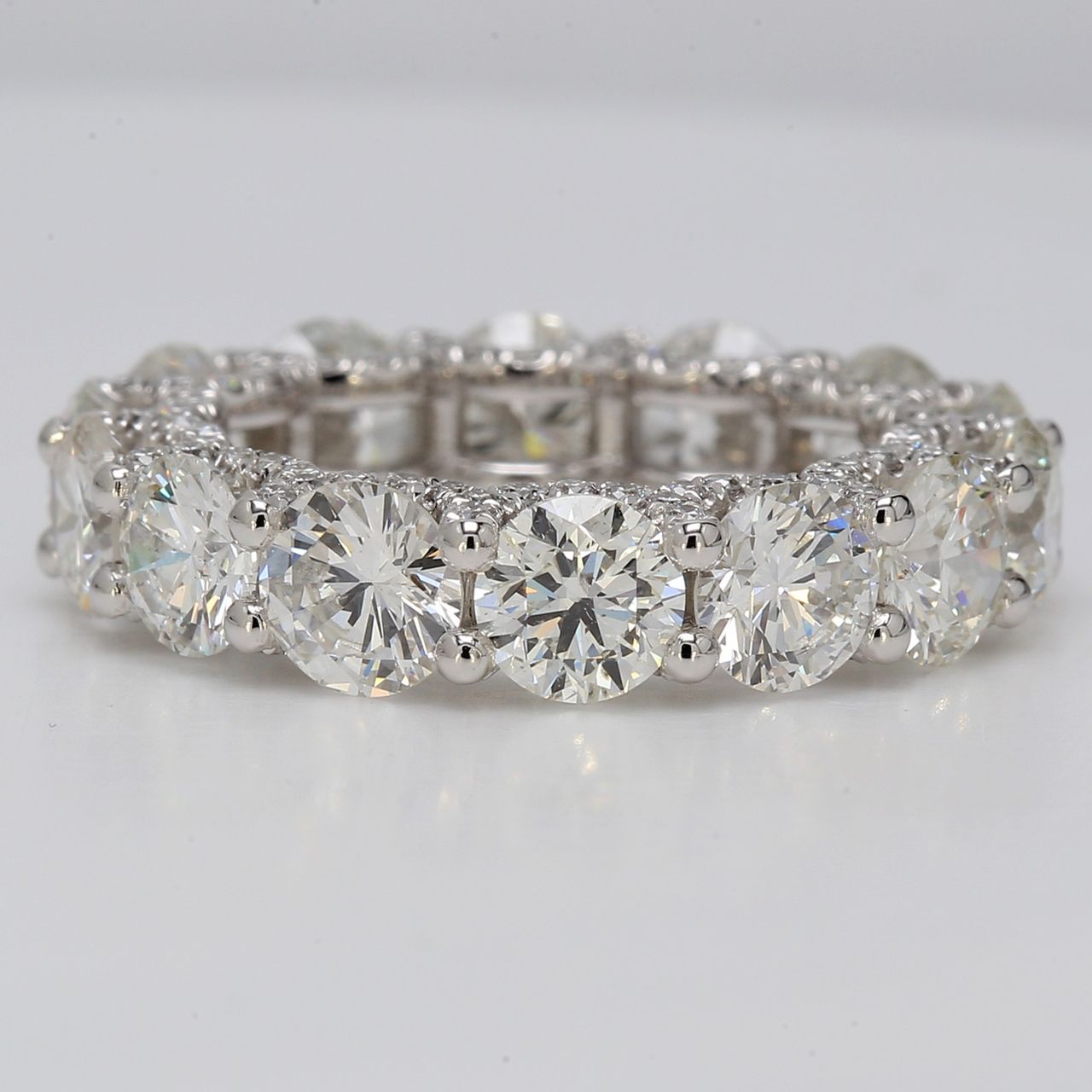 Eternity band in platinum with shared prong set G-H/VS-SI (14) rounds & U-prong set round diamonds on the sides.  D8.36ct.t.w.  Size 6.25