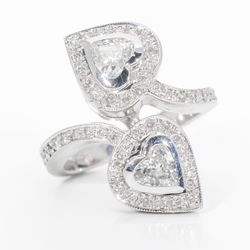 Halo fashion ring with pave set rounds around bezel set heart shape diamond center stones.  D1.22ct.t.w.