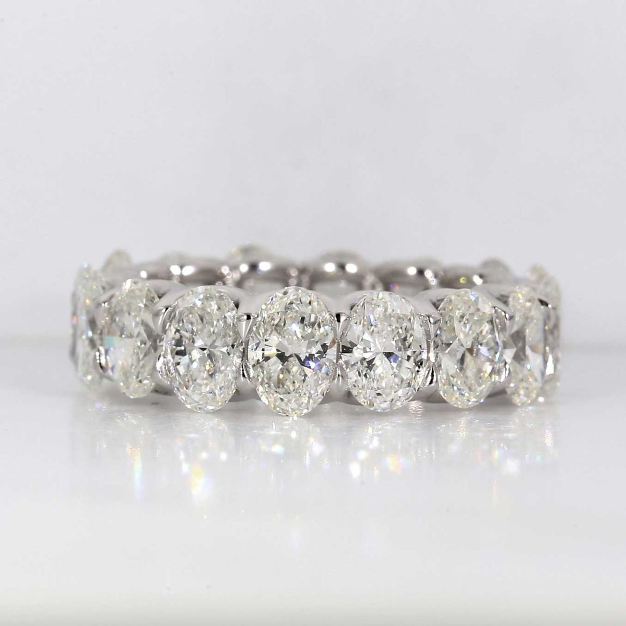 Eternity band in platinum with shared U-prong set GIA certified D-F/VVS2-SI1 (16) oval diamonds.  D6.55ct.t.w.  Size 6.25