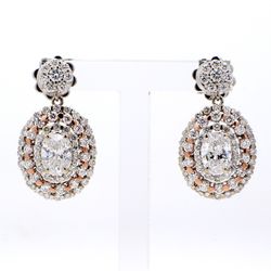 Halo dangling earrings in two-tone with shared prong set rounds & 4-prong set oval diamond centers.  D2.50ct.t.w.  (Centers 1.10ct.t.w.)