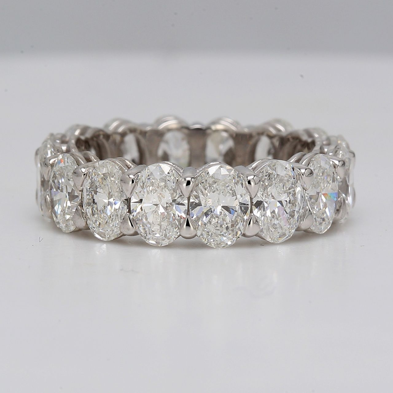 Eternity band in platinum with basket eagle claw set VS-SI1 (16) oval diamonds.  D5.05ct.t.w.  Size 5.5
