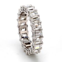 Eternity band in platinum with shared prong set emerald cut diamonds.  D5.35ct.t.w.