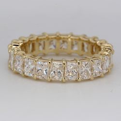 Eternity band in 14K YG with shared claw prong basket set radiant cut diamonds.  D3.40ct.t.w.  Size 5