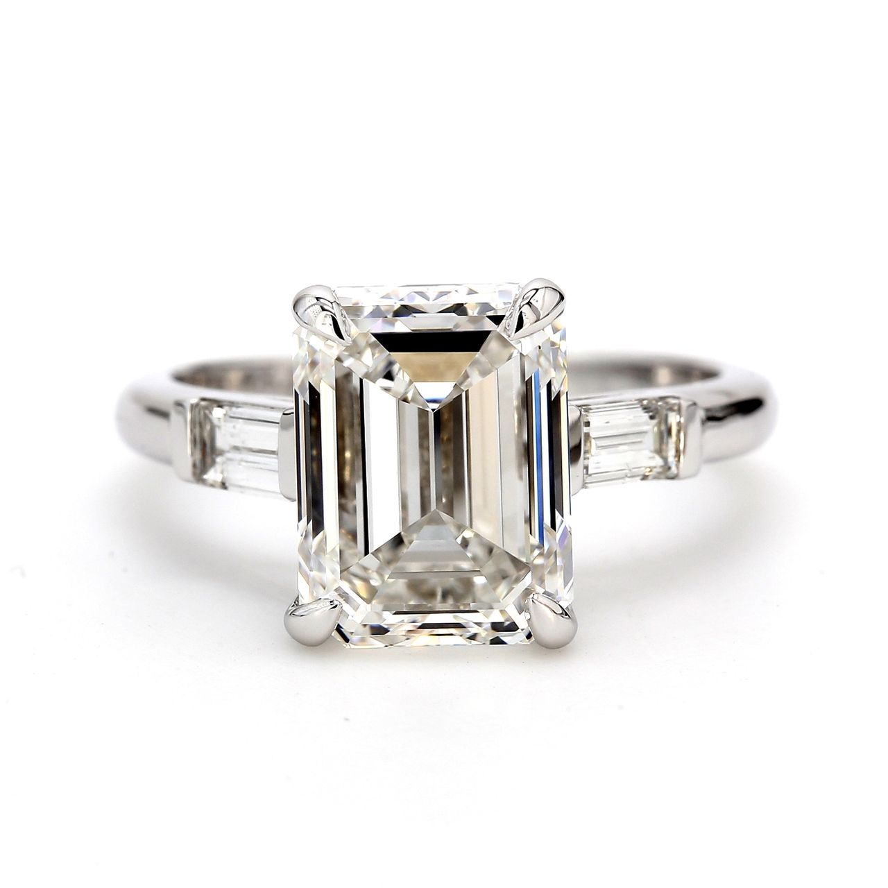 3-stone ring in platinum with channel set baguette sides and F/SI2 GIA certified emerald center.  D3.90ct.t.w.  (Center - 3.51ct.)