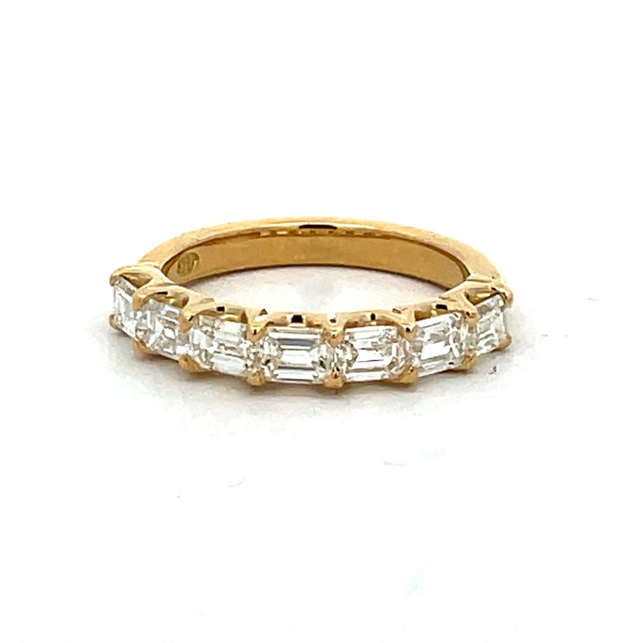 7-stone band east west style in 18K YG with prong set emerald cut diamonds.  D1.33ct.t.w.  Size 5.5
