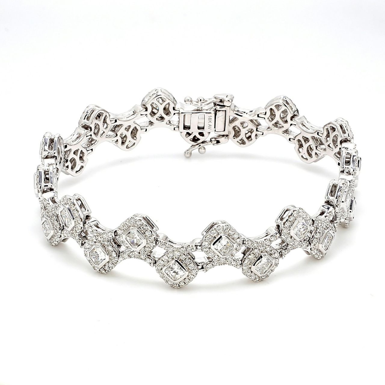 7' Designer bracelet in 18K WG with halo and pave set rounds around bezel set radiant cut diamonds.  D5.81ct.t.w.