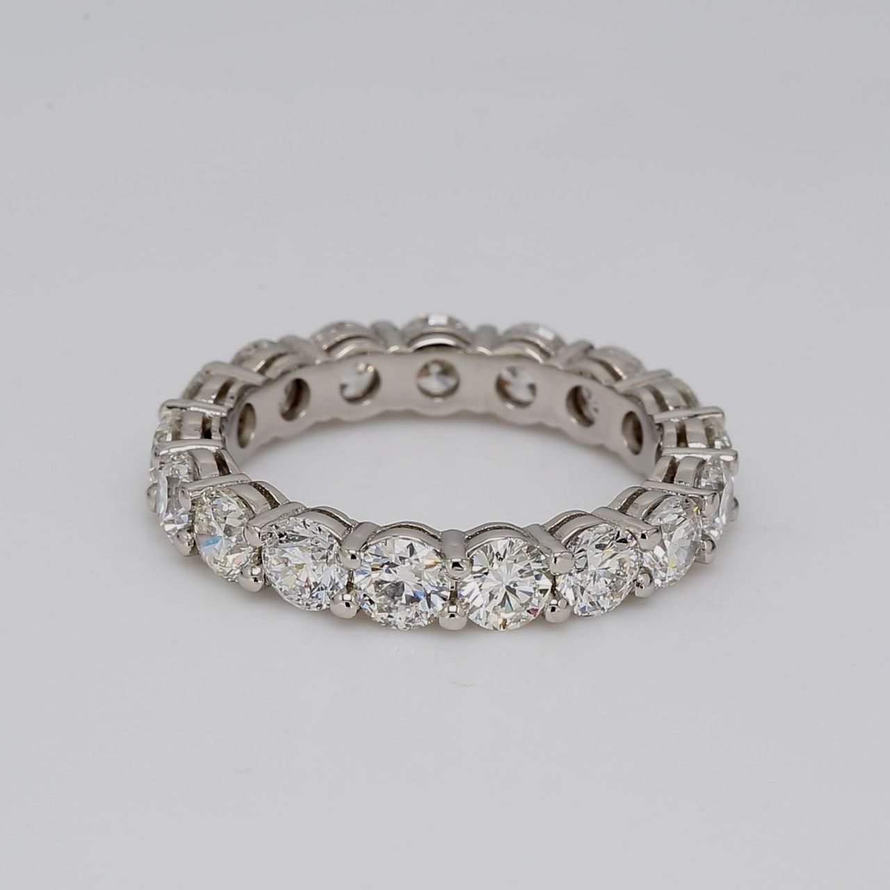 Eternity band in platinum with double basket shared prong set round diamonds.  D3.15ct.t.w.  Size 5.75
