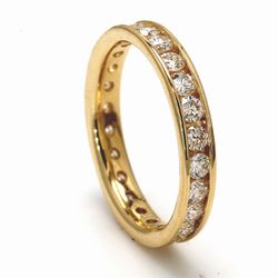 Eternity band in yellow gold with channel set round diamonds.  D0.97ct.t.w.  Size 4.5