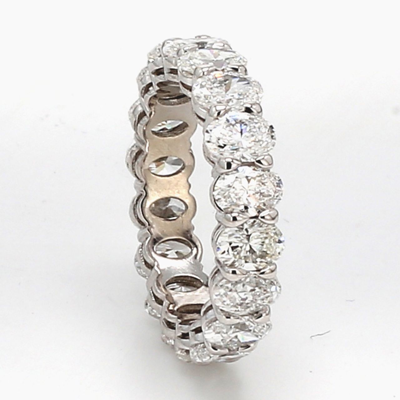 Eternity band in platinum with basket prong set (18) oval diamonds.  D3.37ct.t.w.  Size 4.25