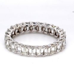 Eternity band in platinum with shared U-prong set emerald cut diamonds.  D4.04ct.t.w.  Size 6.75