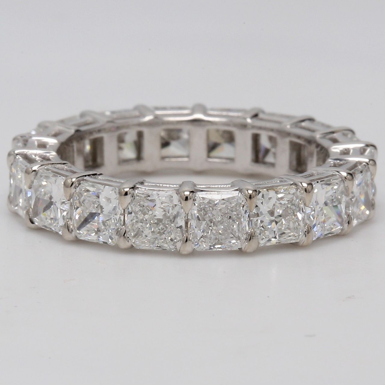 Eternity band in platinum with basket prong set F+/VS+ (18) square radiant diamonds.  D4.41ct.t.w.  Size 6.5