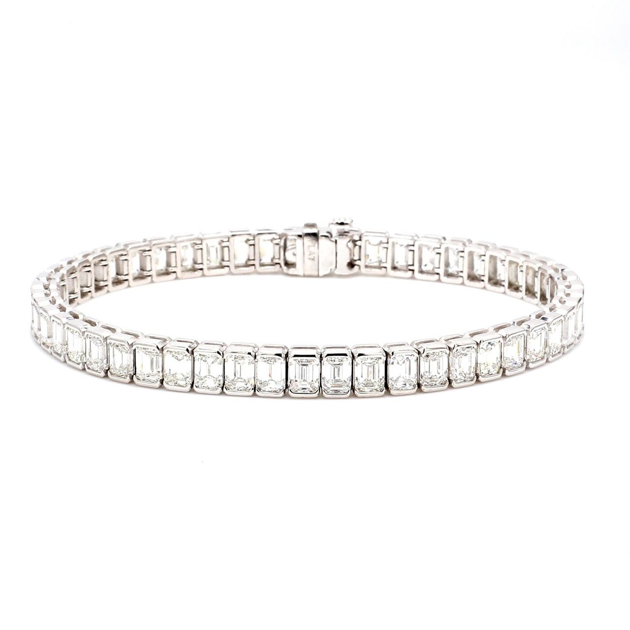 7' Tennis bracelet in platinum with half bezel set (51) emerald cut diamonds.  D15.68ct.t.w.