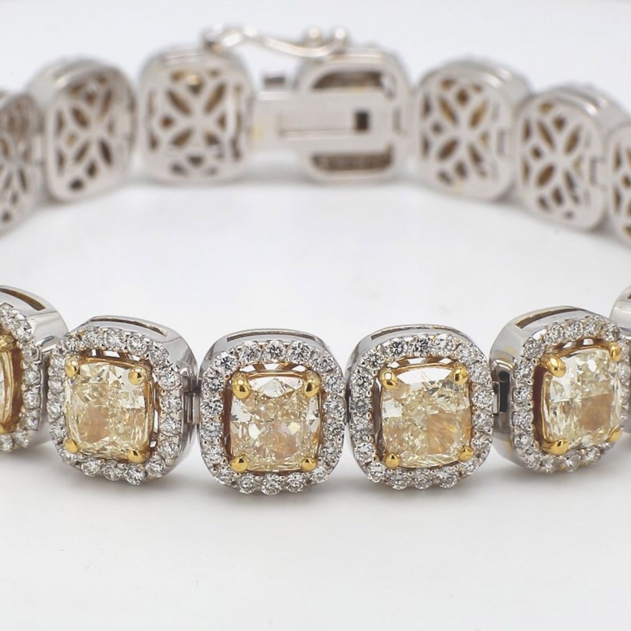 7' Halo tennis bracelet in 18K two-tone with prong set rounds around (20) fancy yellow cushion cut diamond center stones.  D23.97ct.t.w.  (Center - 19.96ct.t.w.)