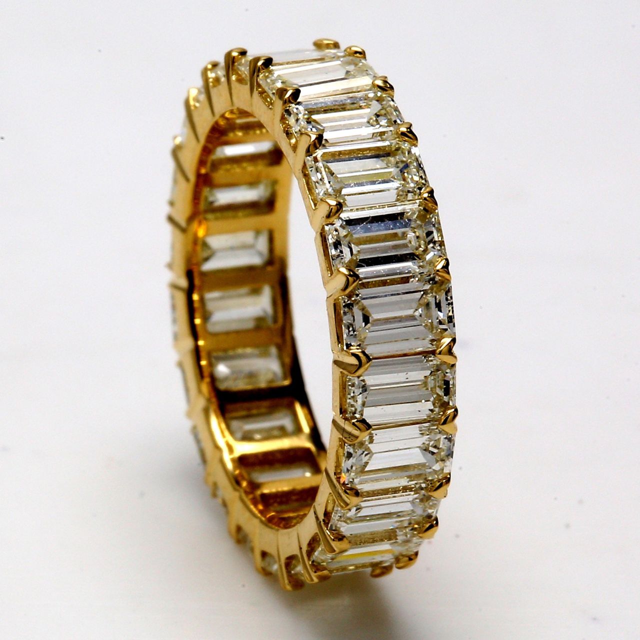 Eternity band in 18K YG with prong set (22) emerald cut diamonds.  D3.72ct.t.w.  Size 4