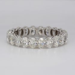 Eternity band in platinum with shared prong double basket set (22) oval diamonds.  D3.26ct.t.w.   Size 6.75