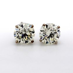 Screw back stud earrings with eagle claw prong set round diamonds.  D3.01ct.t.w.