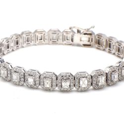 7' Halo tennis bracelet with rounds around prong set (26) emerald cut diamond centers.  D8.92ct.t.w.