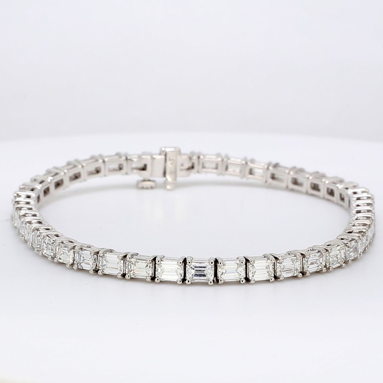 7' Tennis bracelet east to west style in platinum with prong set emerald cut diamonds.  D8.12ct.t.w.