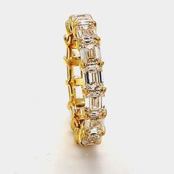 Eternity band east to west style in 18K YG with basket set (15) emerald cut diamonds.  D4.64ct.t.w.  Size 6