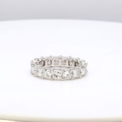 Eternity band in platinum with shared prong basket set (17) princess cut diamonds.  D5.16ct.t.w.  Size 4.75