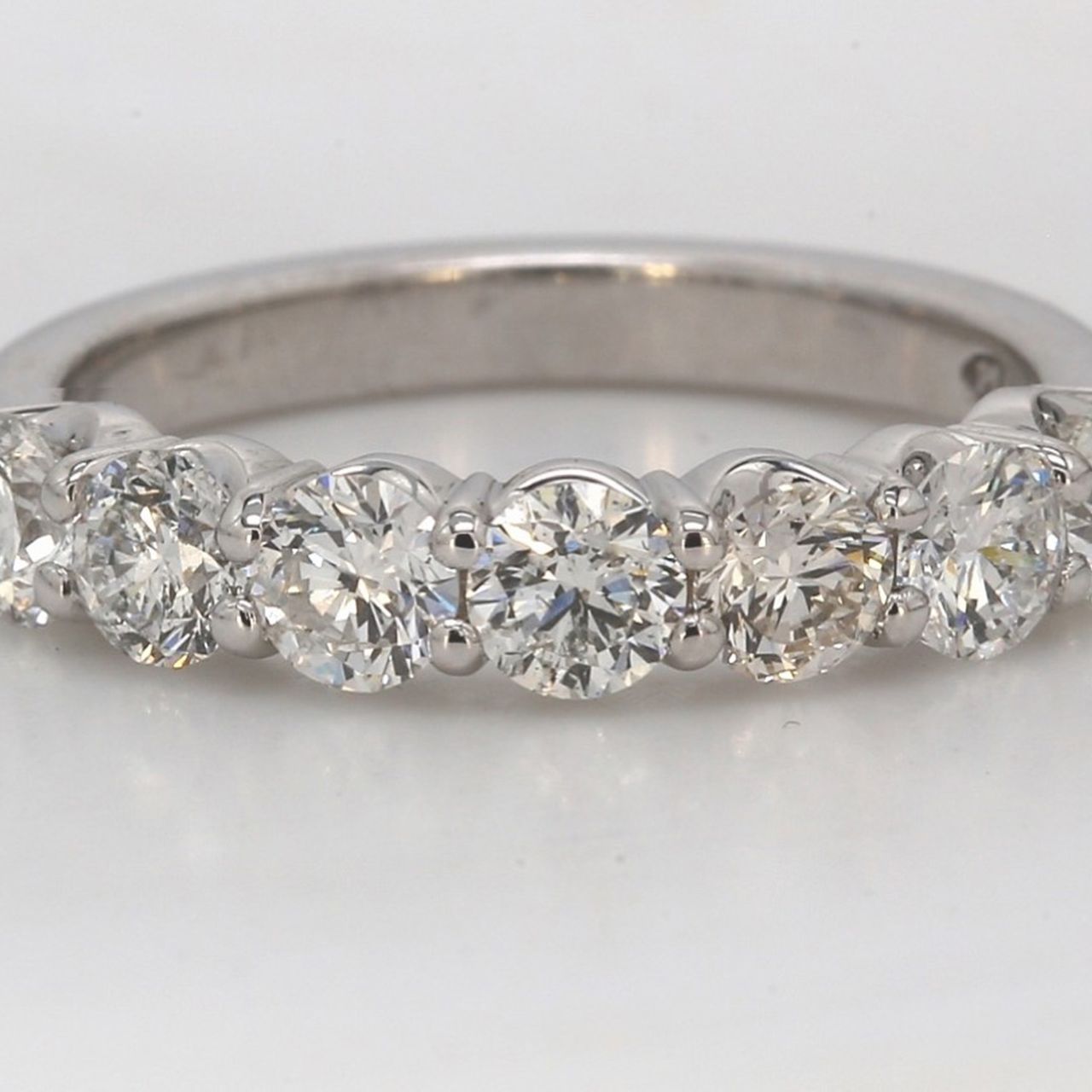 7-stone band in platinum with shared prong set round diamonds.  D1.31ct.t.w.  Size 6