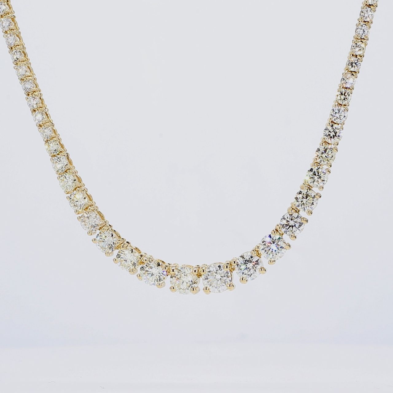17' Graduating tennis necklace in 18K YG with 4-prong set round diamonds.  D17.82ct.t.w.