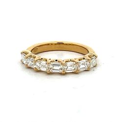 7-stone band east west style in 18K YG with prong set emerald cut diamonds.  D1.33ct.t.w.  Size 5.5