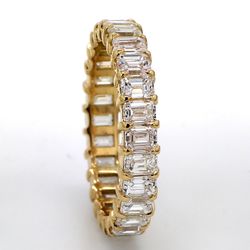 Eternity band in 18K YG with basket prong set (26) emerald cut diamonds.  D3.60ct.t.w.  Size 7