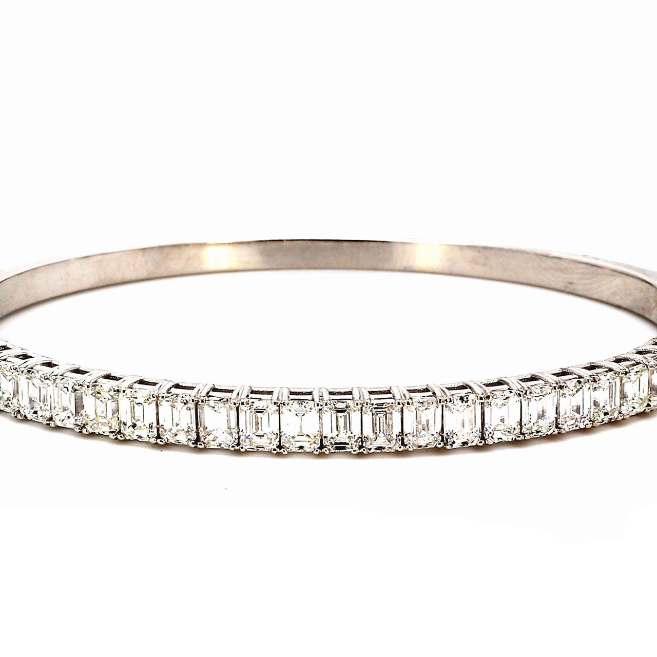 Half way bangle with basket prong  set (27) emerald cut diamonds.  D6.26ct.t.w.