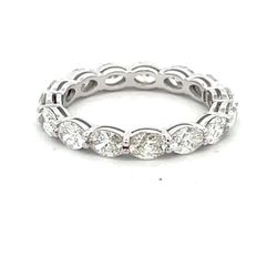 Eternity band east west style in 18K WG open basket prong set (15) oval diamonds.  D2.09ct.t.w.  Size 5.75