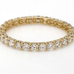 Eternity band in yellow gold with U-prong set (28) round diamonds.  D0.54ct.t.w.  Size 3.5
