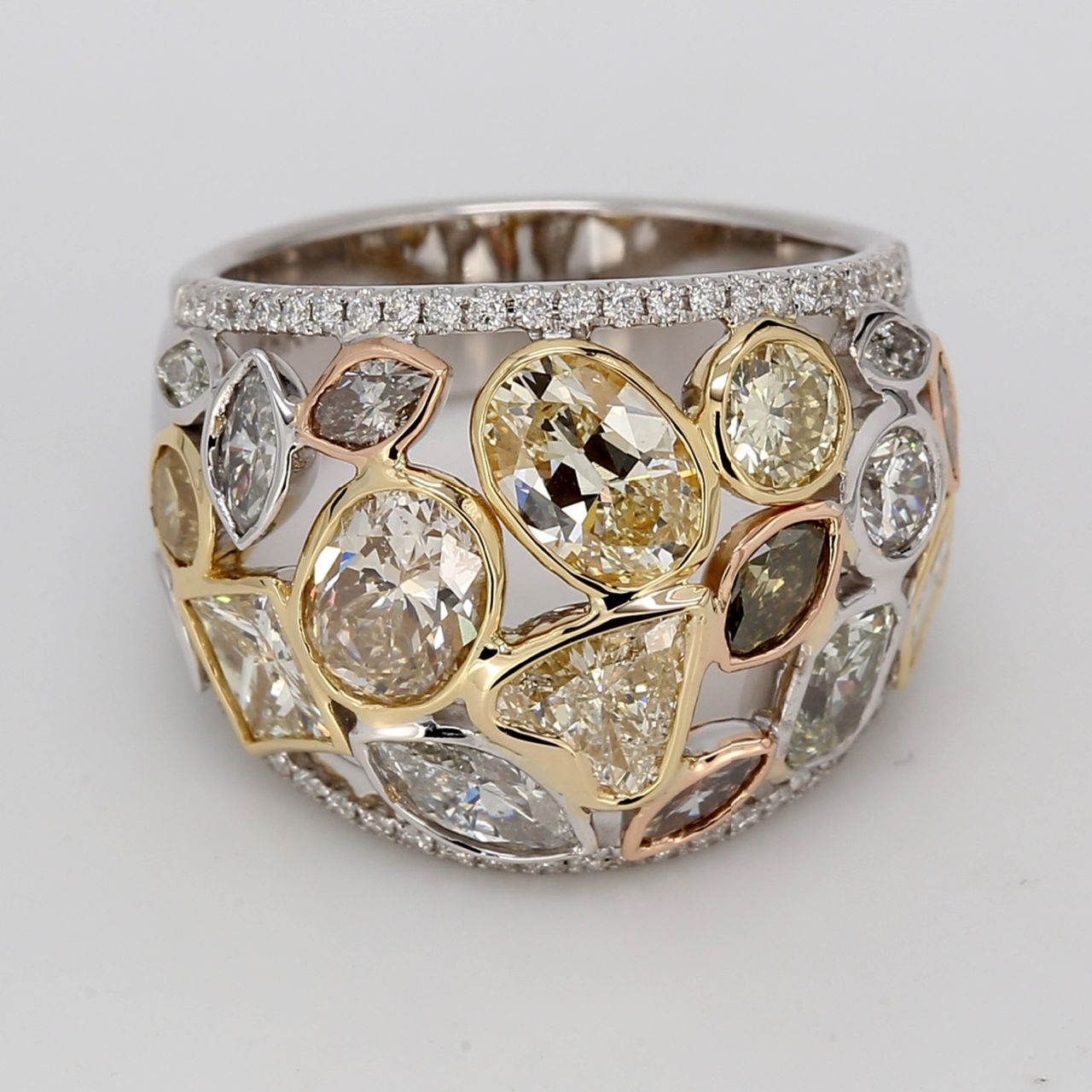 Cocktail band in 18K WG with french pave set round sides & bezel set white and fancy colored assorted shaped diamonds.  D4.98ct.t.w.  Size 6.75