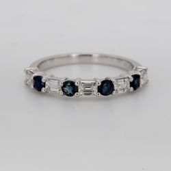 Band in platinum with alternating prong set emerald cut diamonds and round shape sapphires.  D0.76ct.t.w.  Sapphires 0.53ct.t.w.