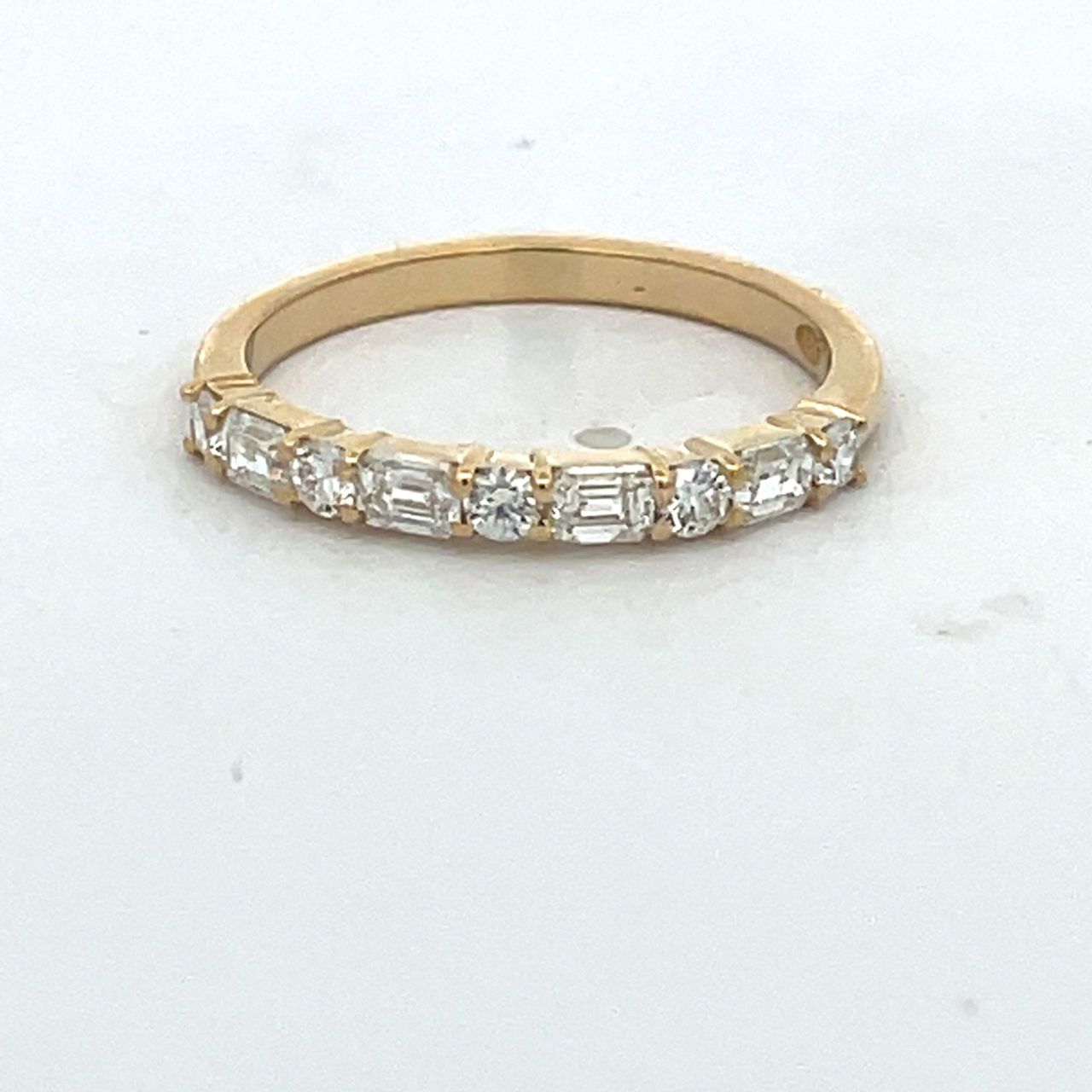 Single row band in 18K YG with prong set alternating (4) emerald cut and (5) round diamonds.  D0.57ct.t.w.  Size 6