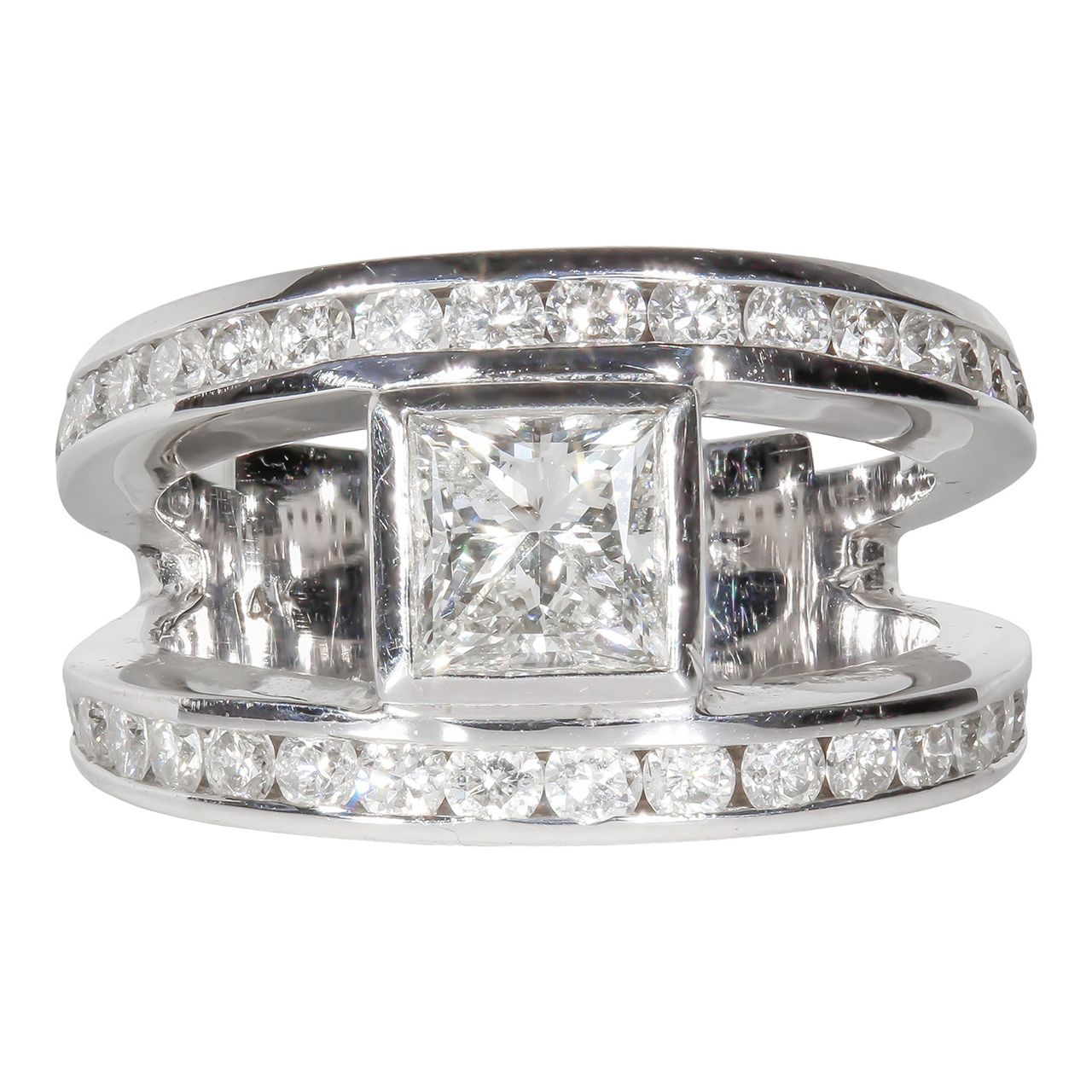 Open shank ring with channel set rounds and bezel set princess cut diamond center stone.  D2.24ct.t.w.  (Center 0.96ct.)