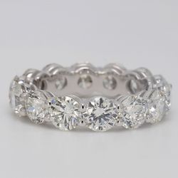 Eternity band in platinum with basket shared prong set G/VS round diamonds.  D6.51ct.t.w.  Size 6.25
