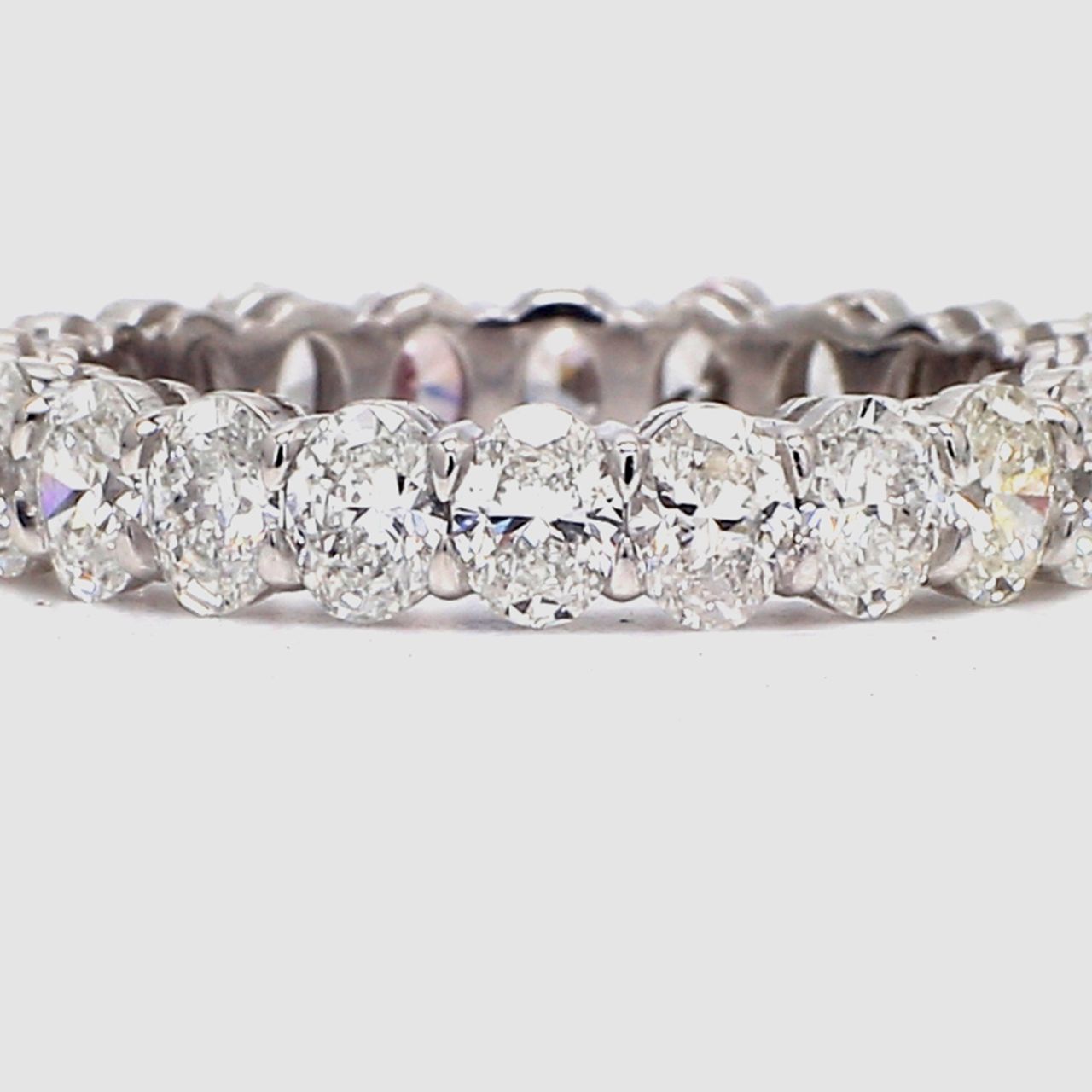 Eternity band in platinum with basket prong set (22) oval cut diamonds.  D3.02ct.t.w.  Size 6.5