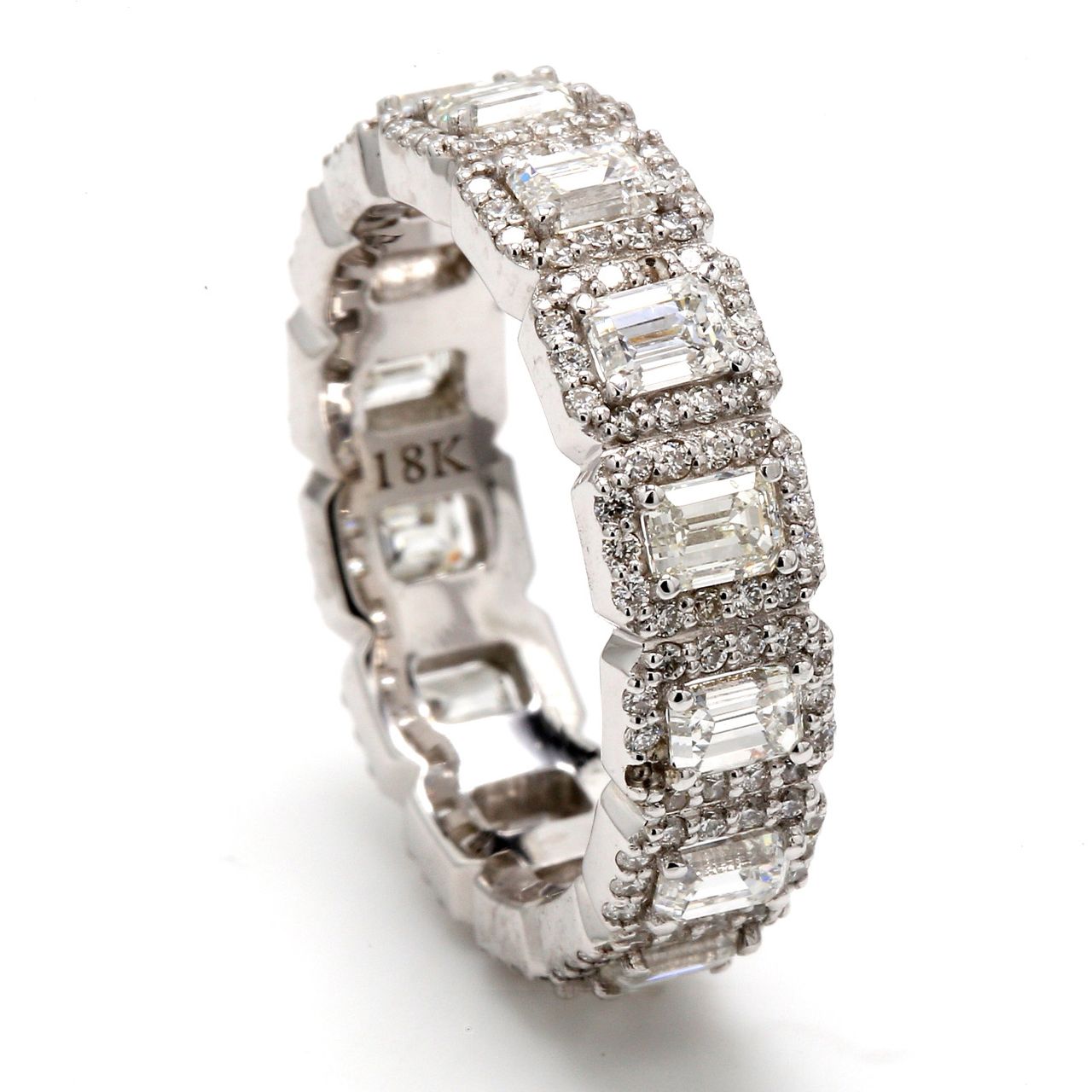 Halo eternity band with pave set round diamond around 4-prong set (14) emerald cut diamonds.  D3.56ct.t.w.  Size 8