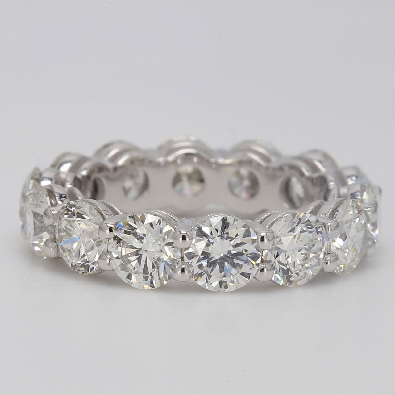 Eternity band in platinum with basket shared prong set G/VS round diamonds.  D6.51ct.t.w.  Size 6.25