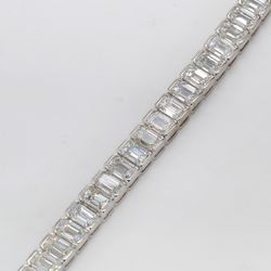 7' Tennis bracelet in platinum with half bezel set emerald cut diamonds.  D13.58ct.t.w.