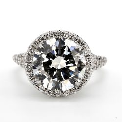 Halo semi-mount in 18K WG prong set round diamond.  D0.62ct.t.w.  Size 6.5