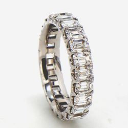 Eternity band in 18K WG with U-prong set (23) emerald cut diamonds.  D3.30ct.t.w.  Size 5
