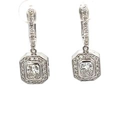 Halo style stud earrings in 18K WG with rounds around bezel set radiant cut diamond center stones.  D1.57ct.t.w.