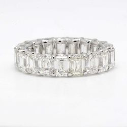 Eternity band in platinum with shared U-prong set (19) emerald cut diamonds.  D5.81ct.t.w.  Size 4.5