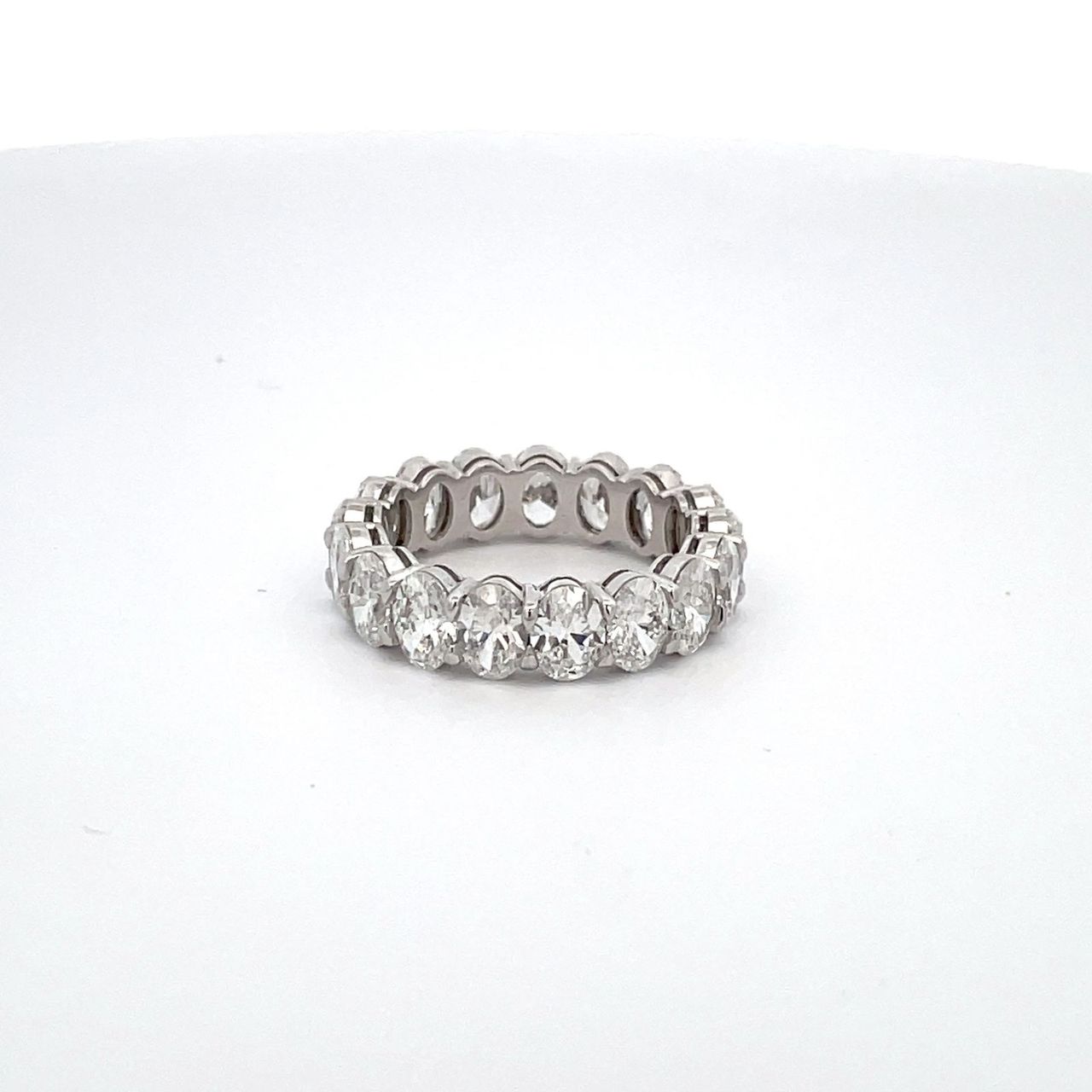 Eternity band in platinum with basket claw prong set GIA certified D-F/VS2-SI2 (17) oval cut diamonds.  D5.26ct.t.w.  Size 6