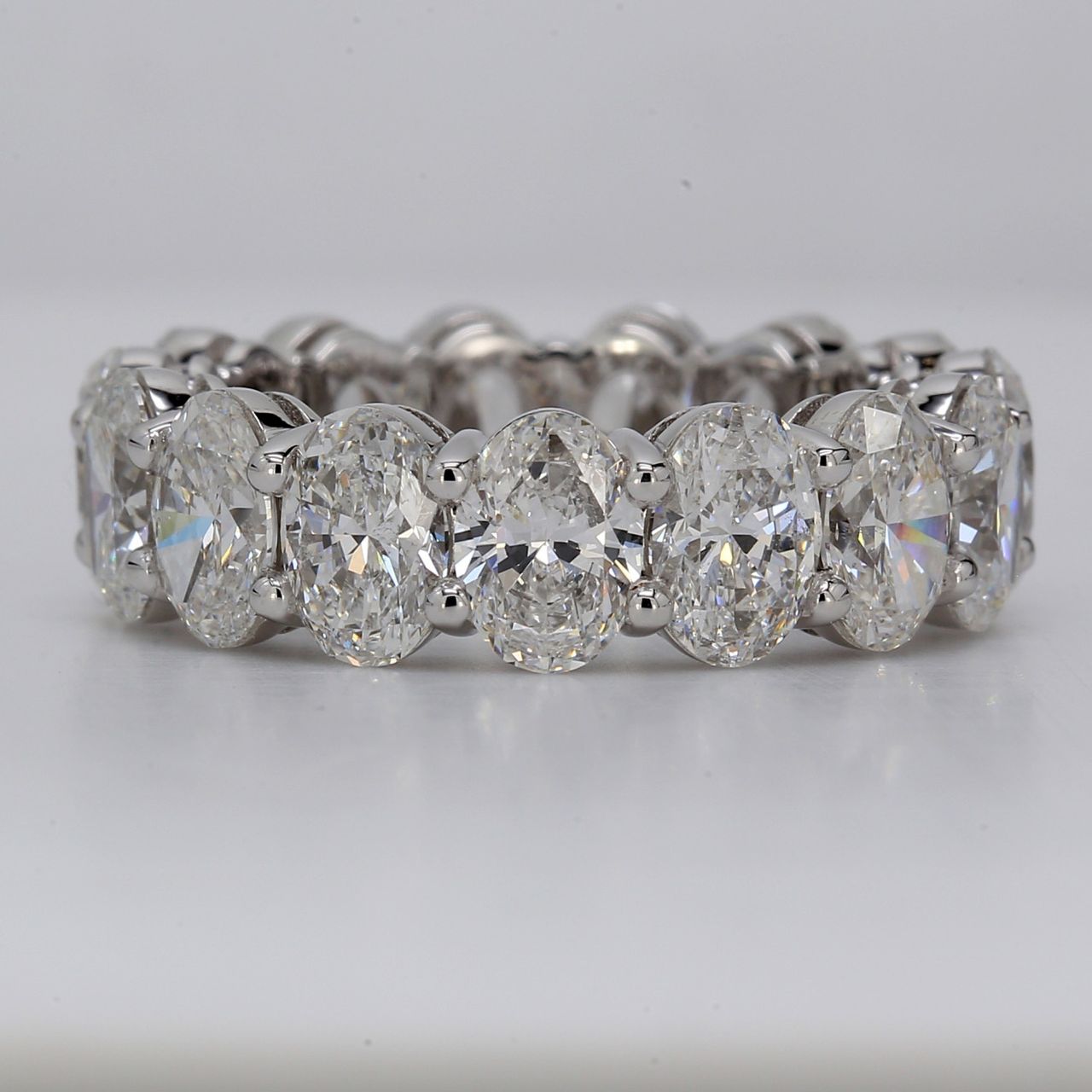 Eternity band in platinum with basket shared prong GIA certified D-F/SI1-SI2 (15) oval diamonds.  D7.71ct.t.w.  Size 6.5
