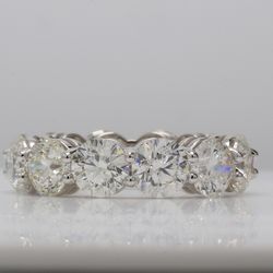 Eternity band in platinum with shared prong set (12) round diamonds.  D8.70ct.t.w.  Size 5.25